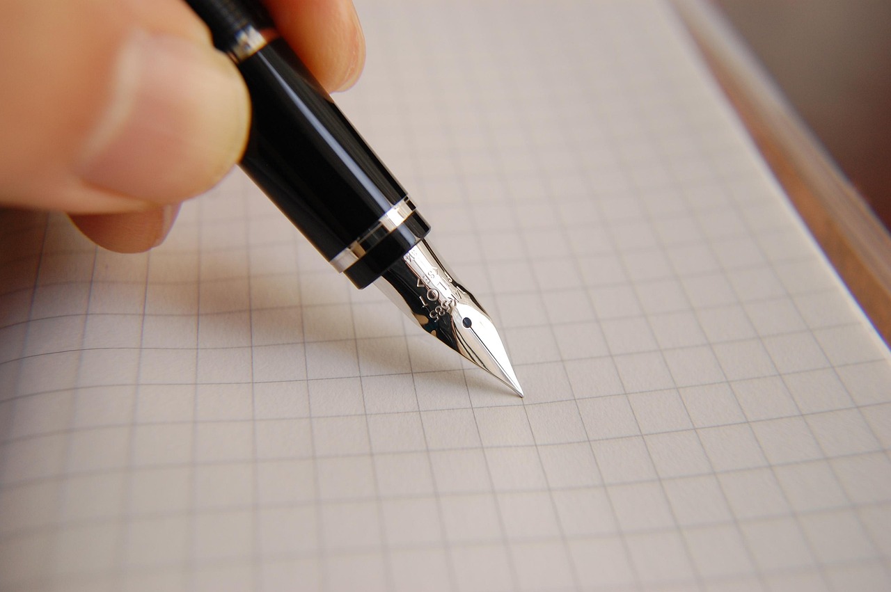 A formal document being signed with a pen signifying a formal appeal or complaint
