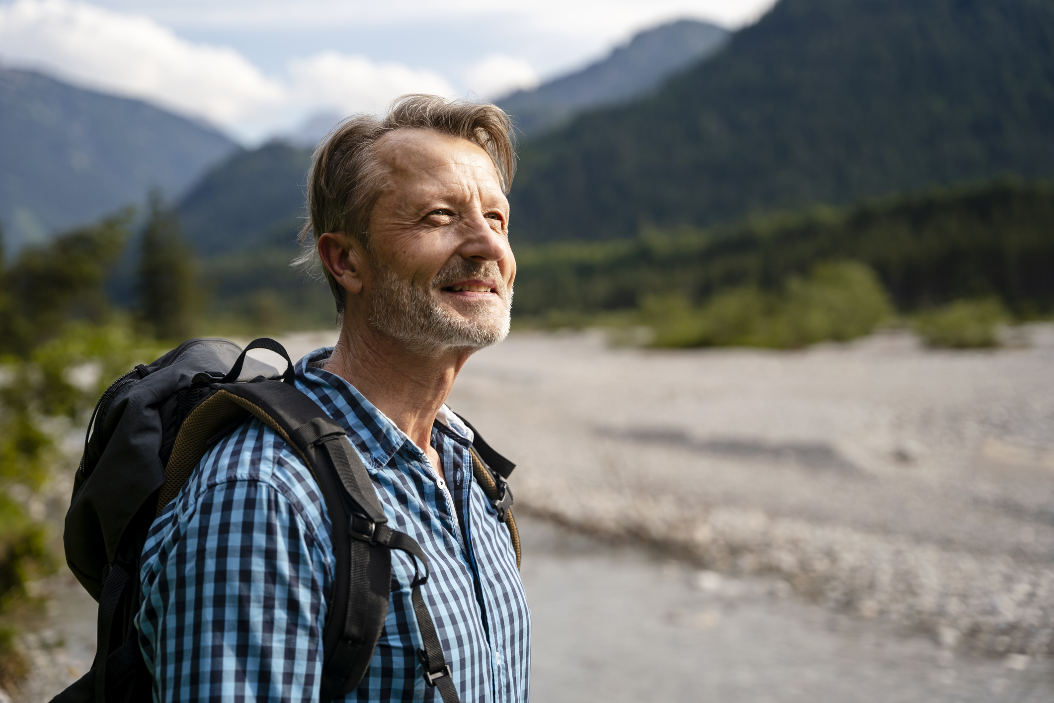 A fit older man enjoying a scenic hike in the mountains.