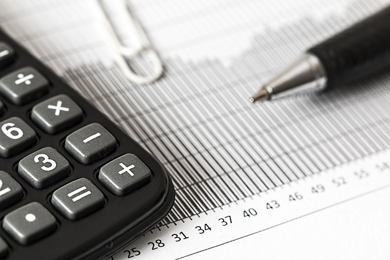 A professional desk setup with a calculator and financial documents.