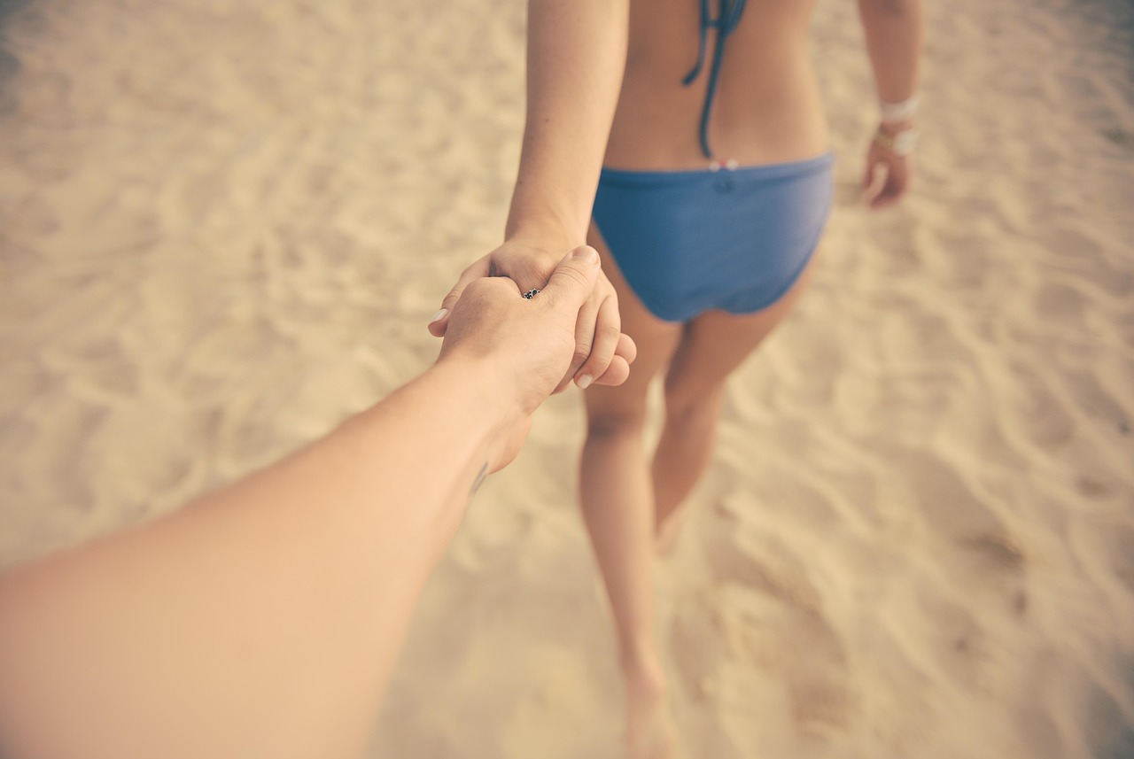 A healthy mature couple walking along a serene beach